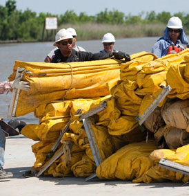 technicians with helmets handling folded yellow boom