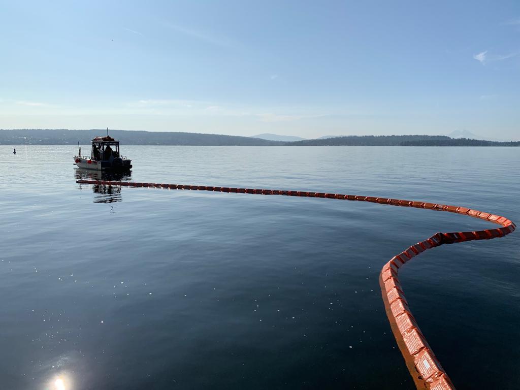 HARBO BOOM deployed on water, small boat on the left